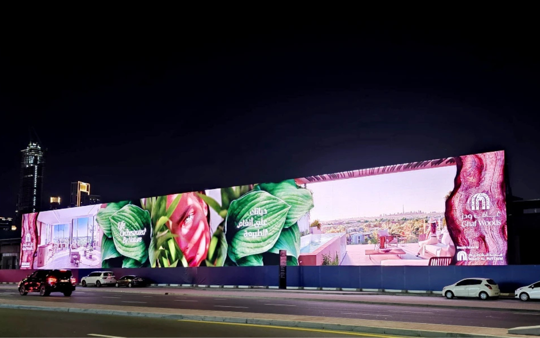 Night time digital billboard display with colorful advertising